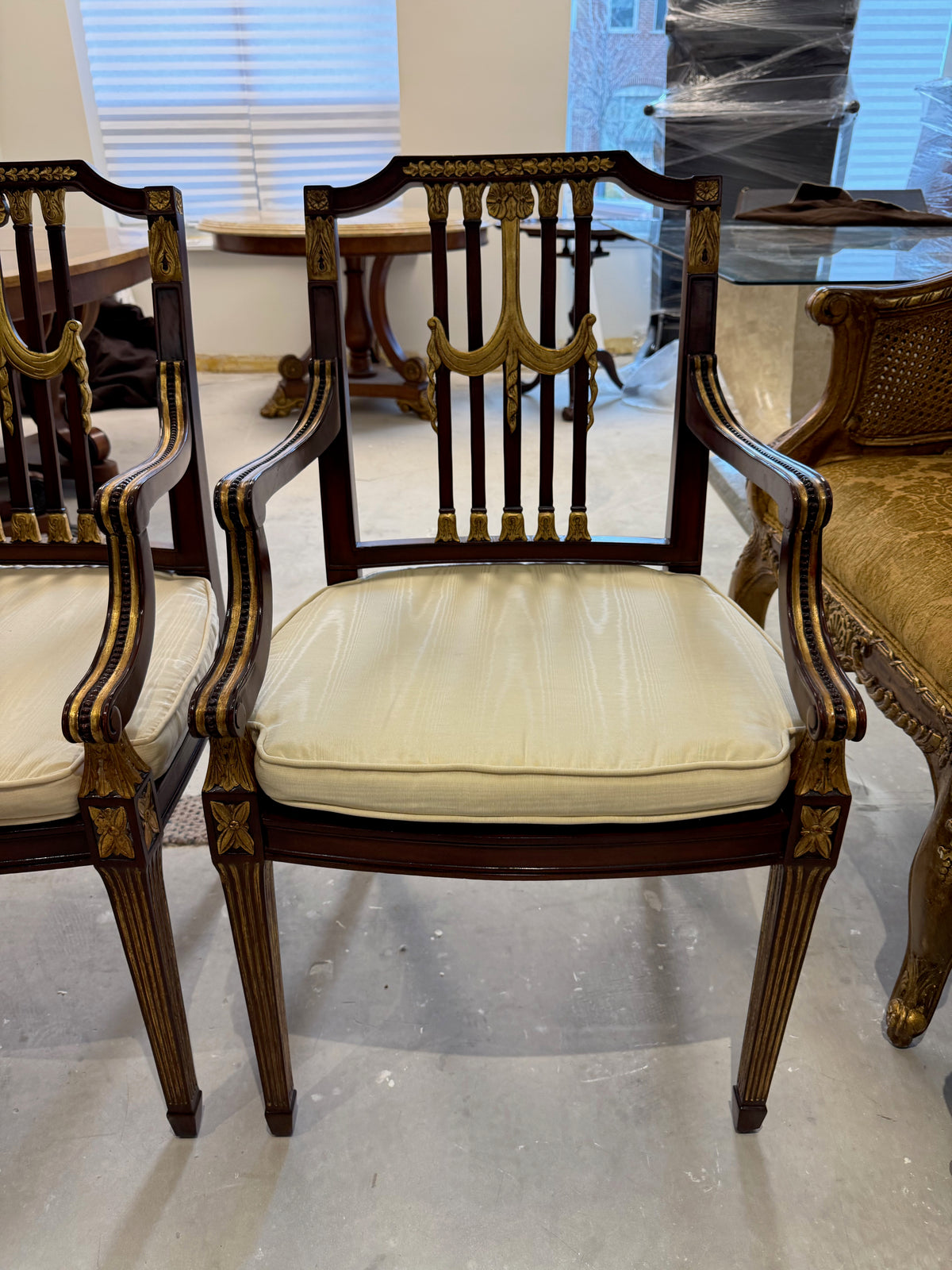 pair of Maitland Smith parcel gilt mahogany and swag shield back cane seat armchairs