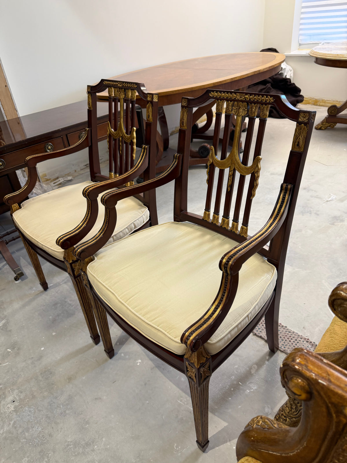 pair of Maitland Smith parcel gilt mahogany and swag shield back cane seat armchairs