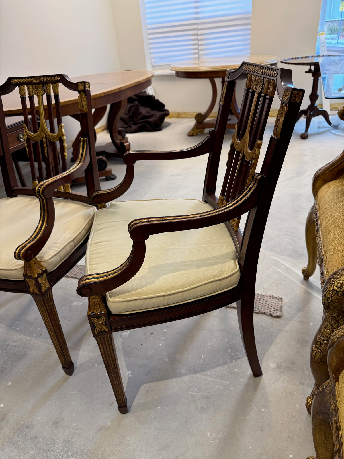 pair of Maitland Smith parcel gilt mahogany and swag shield back cane seat armchairs