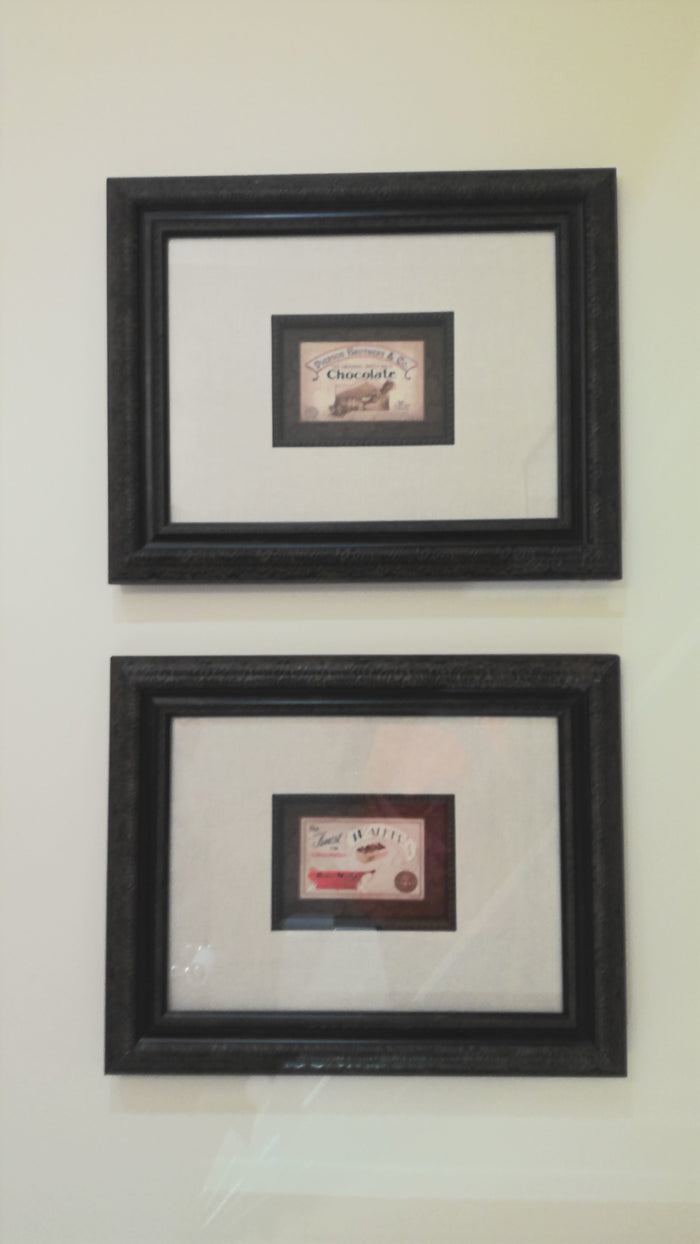 Pair of framed vintage style chocolate wrappers